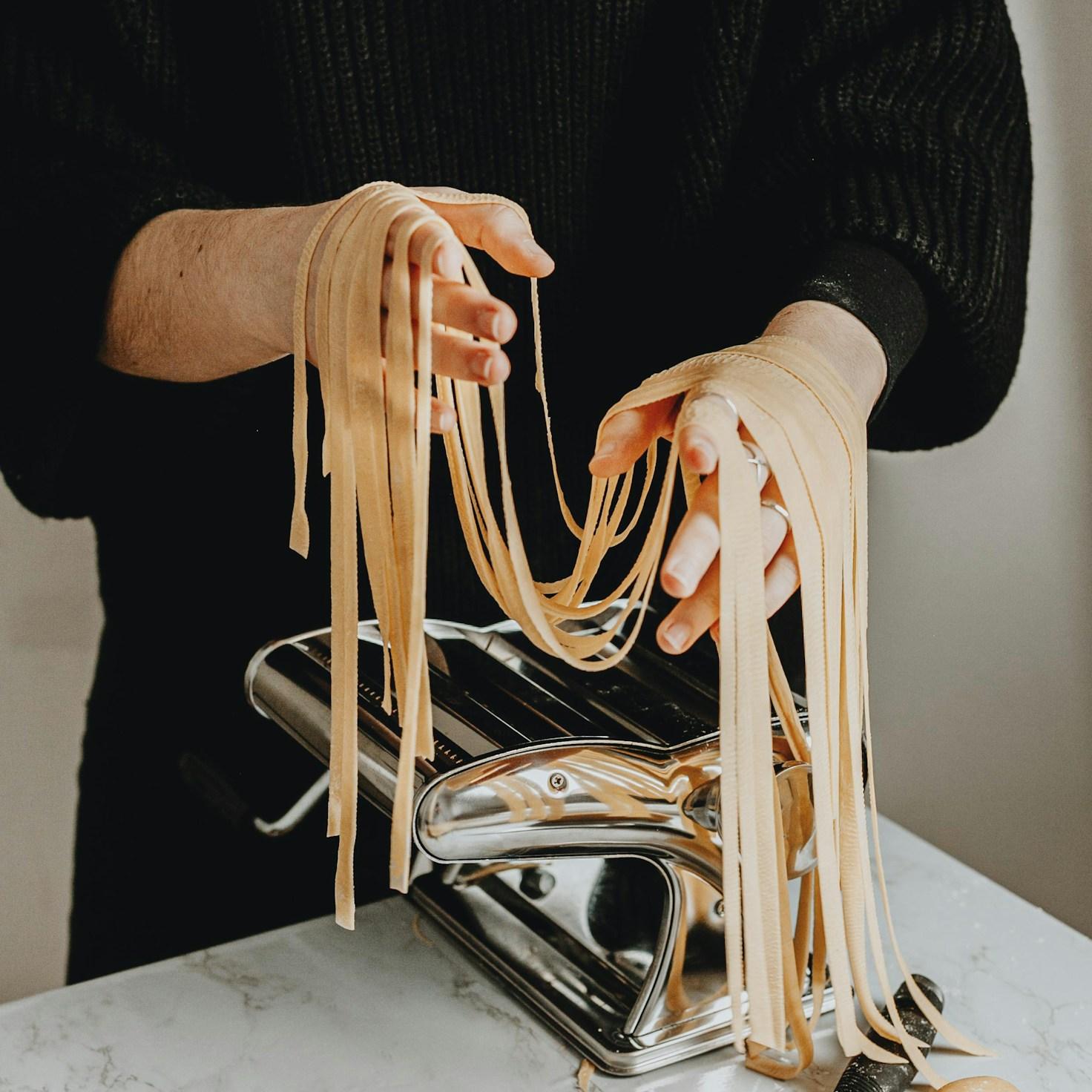 Community members collaborating in a contemporary kitchen, sharing recipes and cooking skills